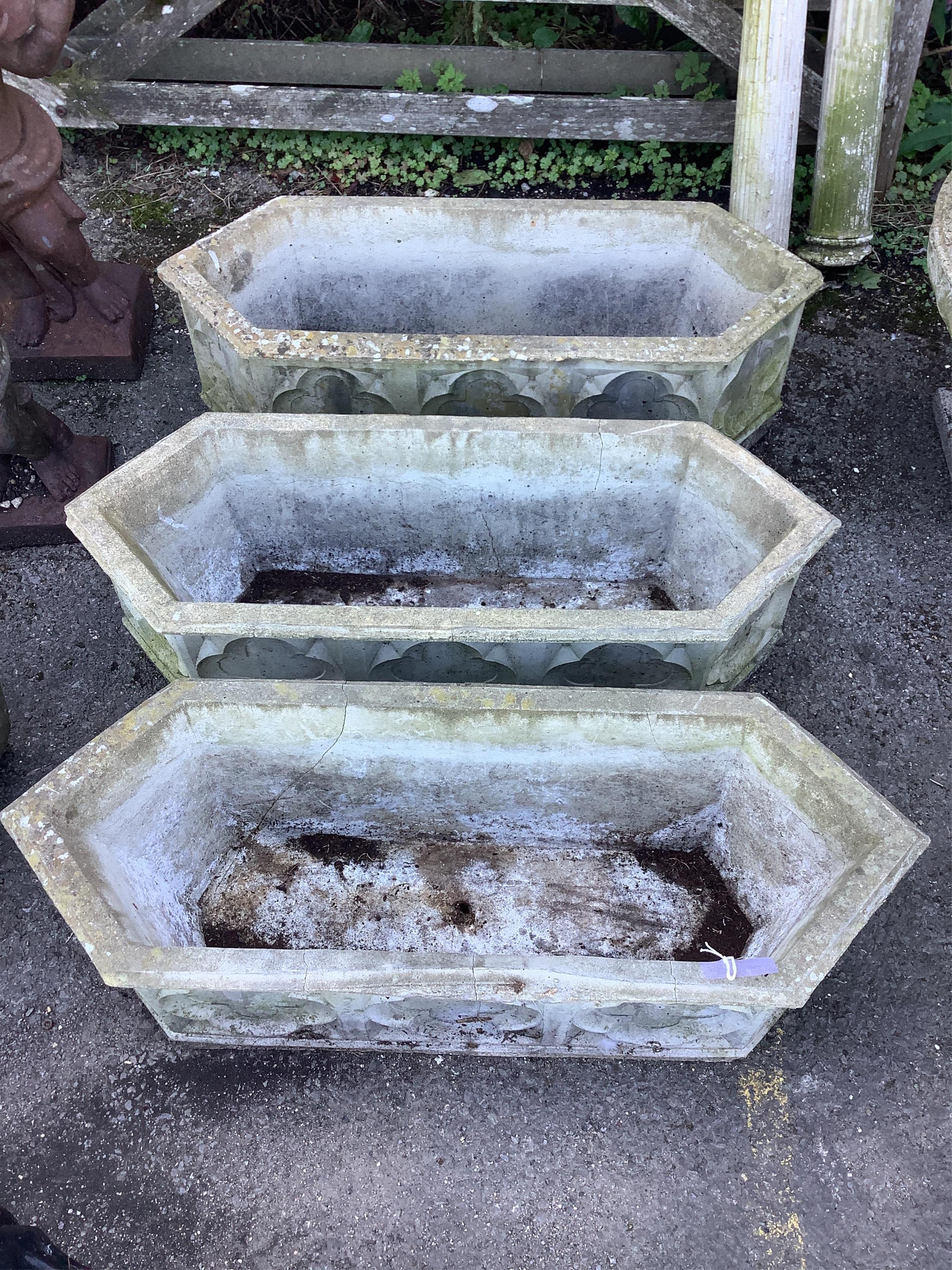 A set of three reconstituted stone hexagonal garden planters, width 89cm, depth 32cm, height 28cm. Condition - poor to fair